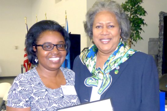 Zena Nelson (left), an industrial account executive for Entergy Louisiana, receives an appreciation award from Jackie Alexander, Girl Scouts Louisiana East CEO. 